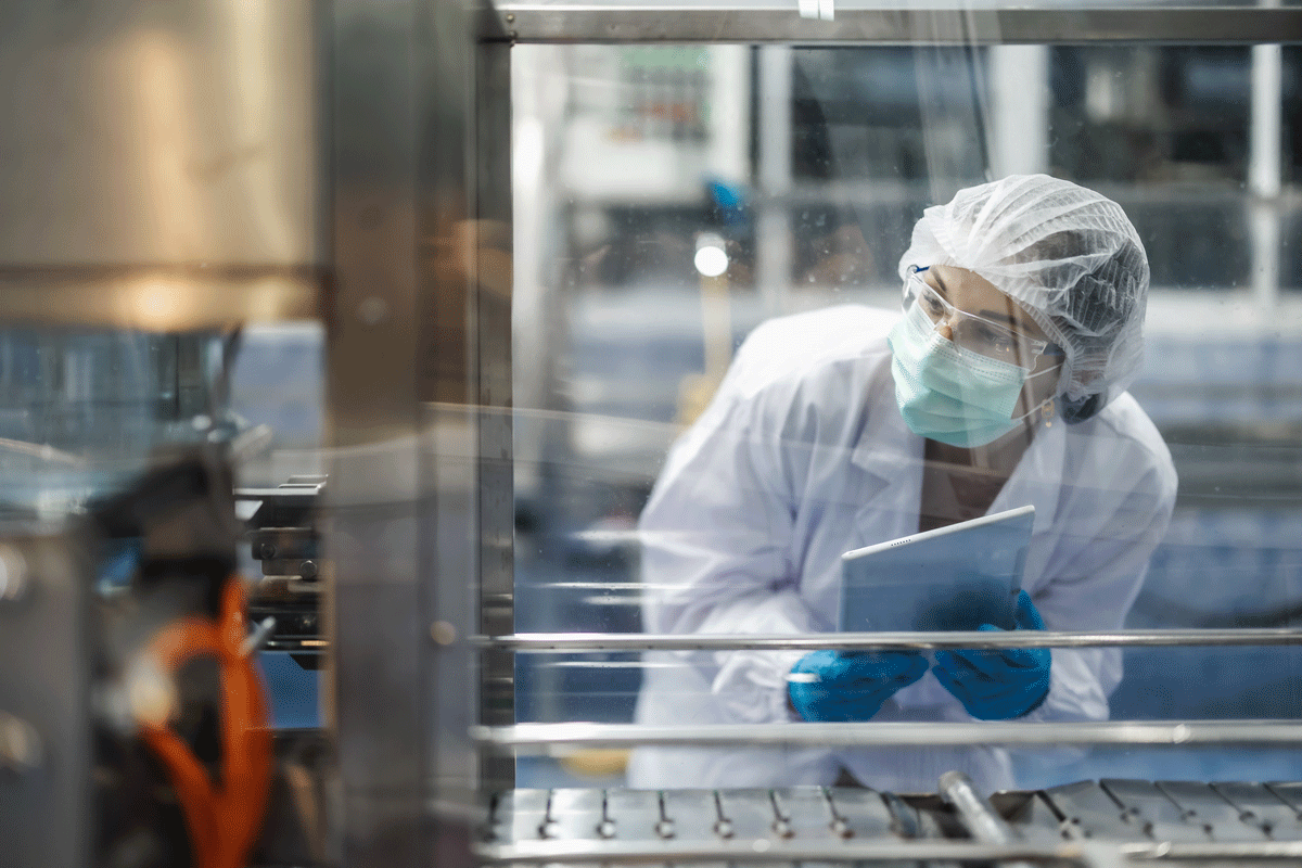 pharmaceutical-worker-looking-at-factory-equipment